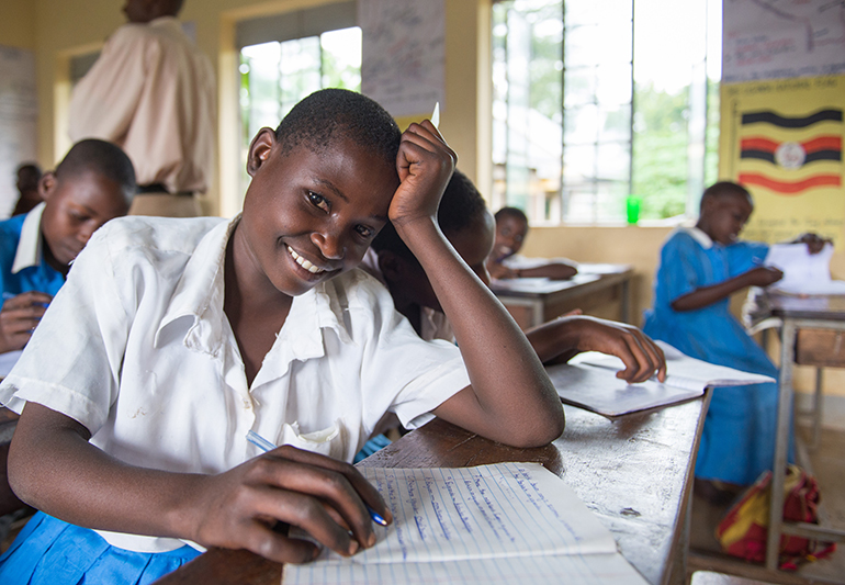 African schoolgirl smiling in class. COALITION FOR GOOD SCHOOLS.